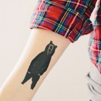 Black ink bear tattoo forearm