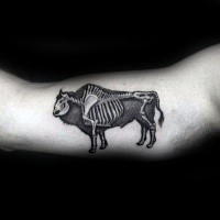 Black ink biceps tattoo of grunting ox skeleton