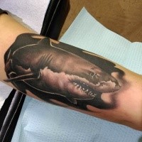 Black ink biceps tattoo of shark