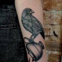 Black ink bird and teacup forearm tattoo