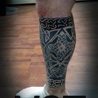 Black ink Celtic style leg tattoo of various knots