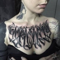 Black ink chest tattoo of mystical ambigram