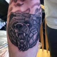 Black ink creepy looking forearm tattoo of zombie bear head