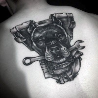 Black ink detailed back tattoo of bike engine with dog