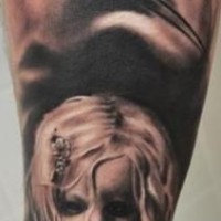 Black ink detailed black ink mystical woman face tattoo on forearm with creepy doll