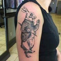Black ink detailed fantasy gentleman rabbit tattoo on upper arm