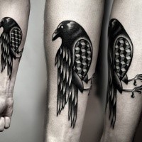 Black ink detailed forearm tattoo of crow with geometrical figures