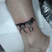 Black ink detailed leg tattoo of wolf stylized with night sky and mountains