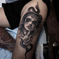 Black ink detailed looking tattoo of creepy witch with snake