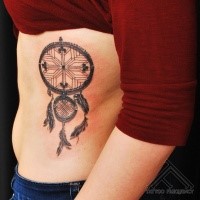 Black ink detailed side tattoo of cool dram catcher