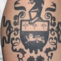 Black ink family crest tattoo on shoulder