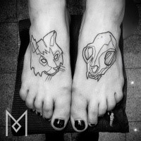 Black ink feet tattoo of cat skull and cat head