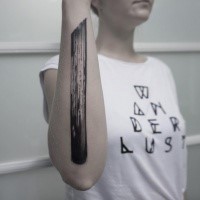 Black ink forearm tattoo of big wooden stick