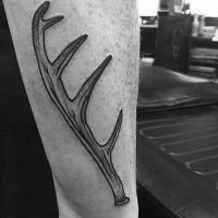Black ink forearm tattoo of deer horn