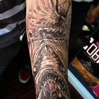 Black ink forearm tattoo of demonic shark and sinking woman