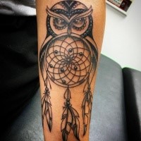 Black ink forearm tattoo of dream catcher and owl