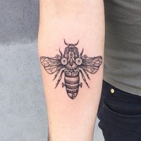 Black ink forearm tattoo of mechanical bee