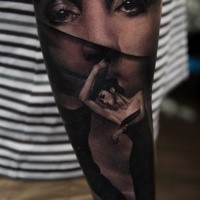 Black ink forearm tattoo of mystical woman face
