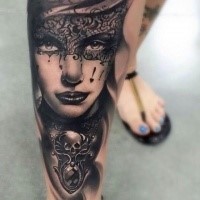 Black ink gorgeous looking arm tattoo of woman with mask and jewelry