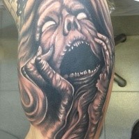 Black ink horror style creepy monster woman face tattoo on biceps