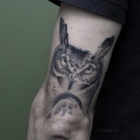 Black ink illustrative style arm tattoo of big owl