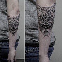 Black ink interesting looking mystical cat tattoo on forearm