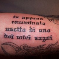 Black ink italian quote tattoo on arm