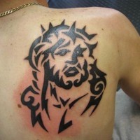 Black ink jesus tattoo on shoulder blade