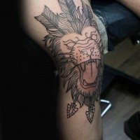 Black ink large lion head with arrows tattoo on knee