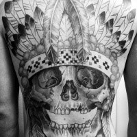 Black ink large whole back tattoo of detailed Indian skull with feather helmet
