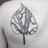 Black ink leaf shaped by Dino Nemec scapular tattoo stylized with tree
