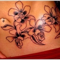 Black ink orchids tattoo on stomach