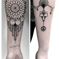 Black ink ornamental style arm tattoo of beautiful ornamental flower
