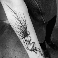 Black ink painted by Inez Janiak forearm tattoo of strange woman sketch