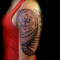 Black ink polynesian tattoo on shoulder