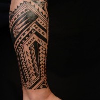 Black ink polynesian tattoo on leg