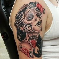 Black ink shoulder tattoo of Mexican woman with tattoos and flowers