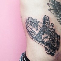 Black ink side tattoo of biomechanical hands and flowers