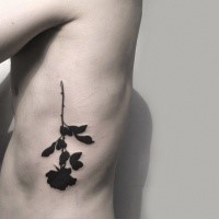 Black ink side tattoo of mystical rose