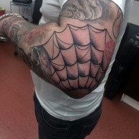 Black ink spider web tattoo on elbow