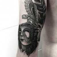 Black ink surrealism style arm tattoo of woman face with lizard skeleton and feather