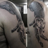Black ink surrealism style shoulder tattoo of human body with big fish