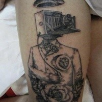 Black ink thigh tattoo of human body with old camera and hat