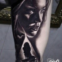 Black ink thigh tattoo of sexy woman with chair