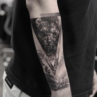 Black ink triangle shaped arm tattoo of leopard portrait with jungle forest
