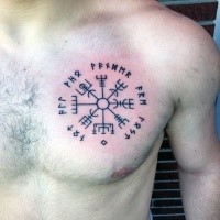 Black ink typical chest tattoo of ancient lettering