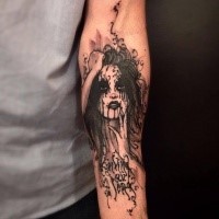 Black ink typical forearm tattoo of creepy woman with lettering