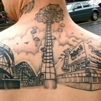 Black ink upper back tattoo of old roller coaster park
