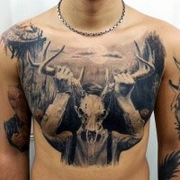 Black ink very detailed chest tattoo of mystical man with deer skull