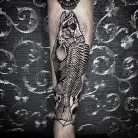 Black ink very detailed forearm tattoo of fish skeleton